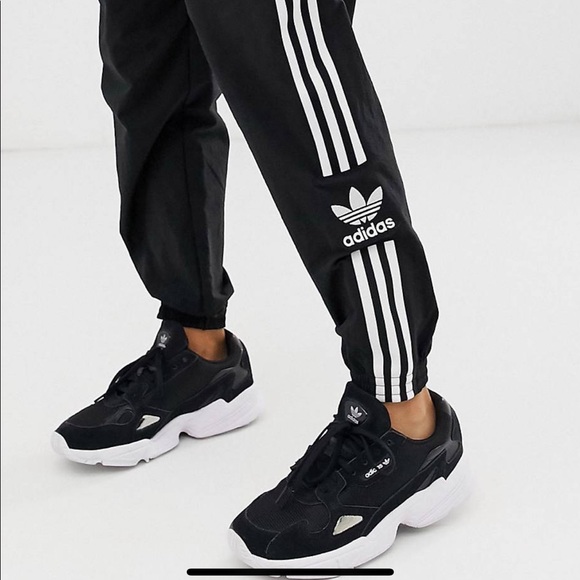 adidas originals adicolor locked up logo track pants in black